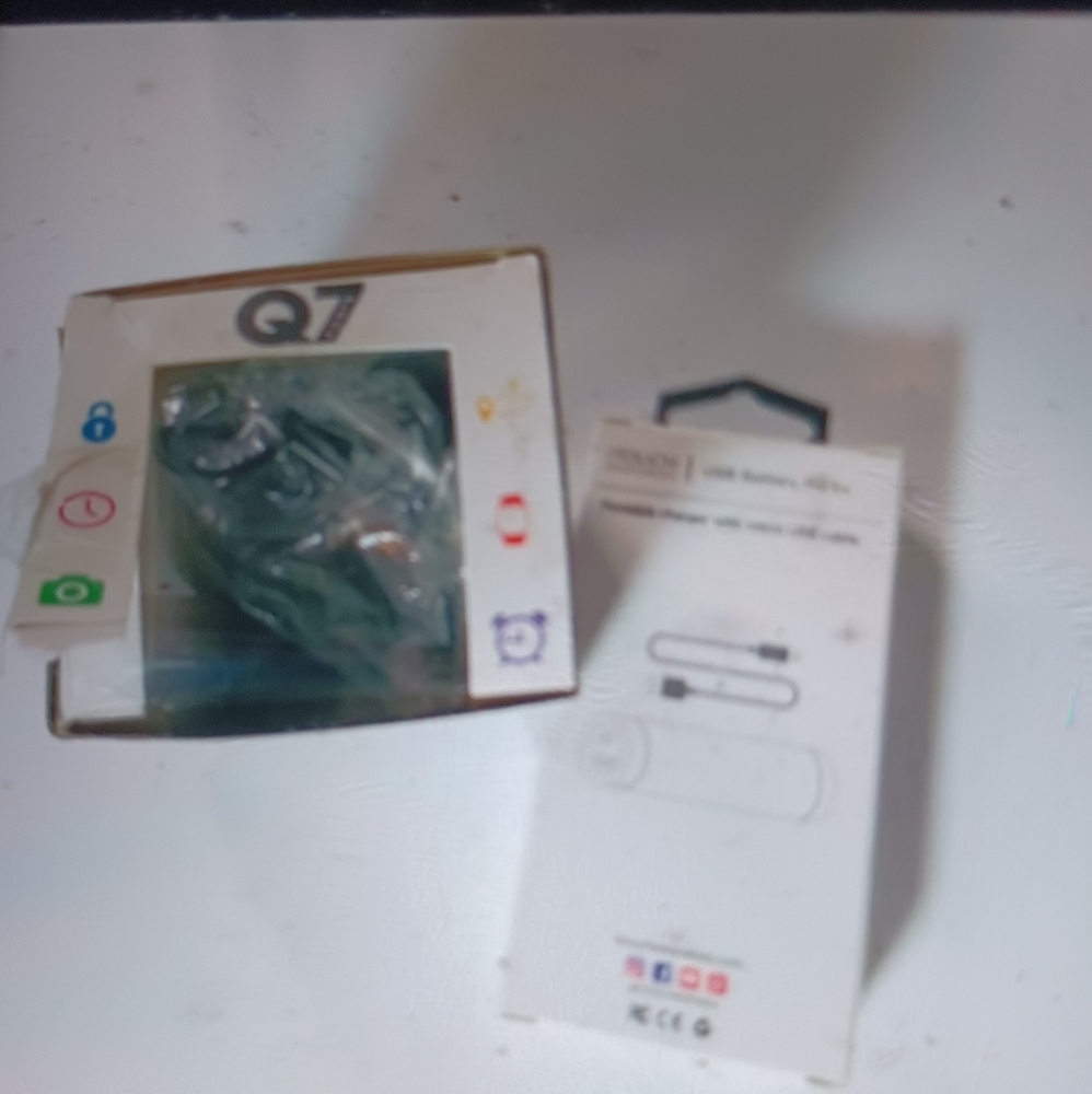 Q7 Sport Watch and rechargeable battery